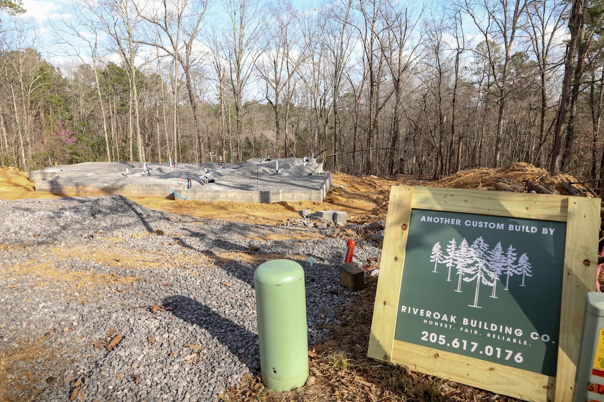 Cleared lot with Riveroak sign at the Trussville Cottage site