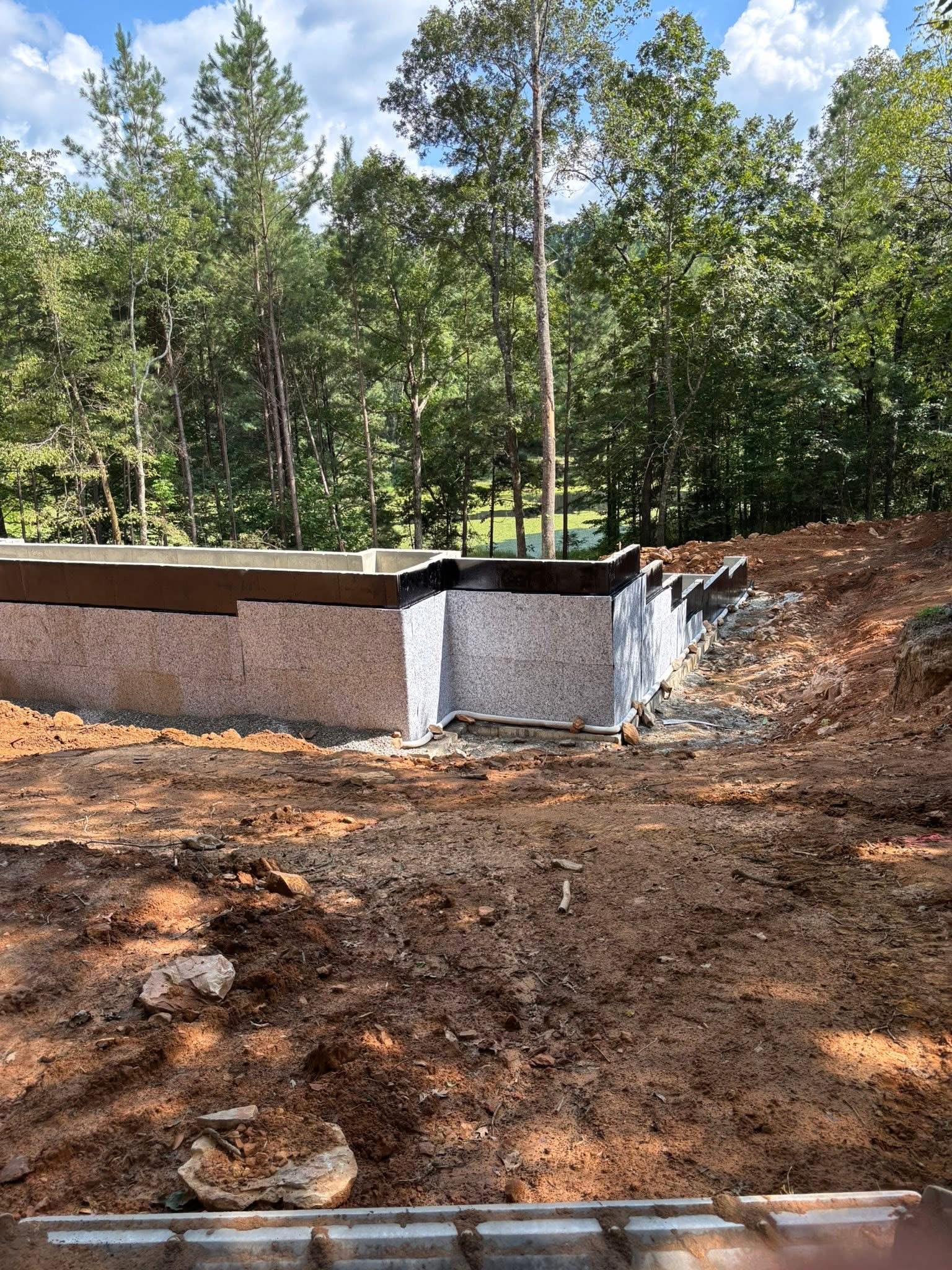 Waterproofed foundation and drainage system installed along the lake-facing side