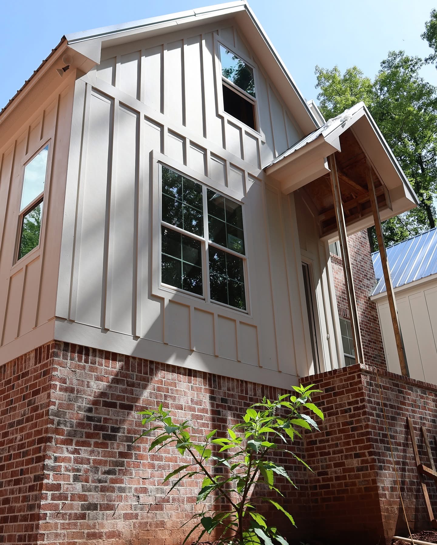 Side elevation showing board-and-batten above brick foundation